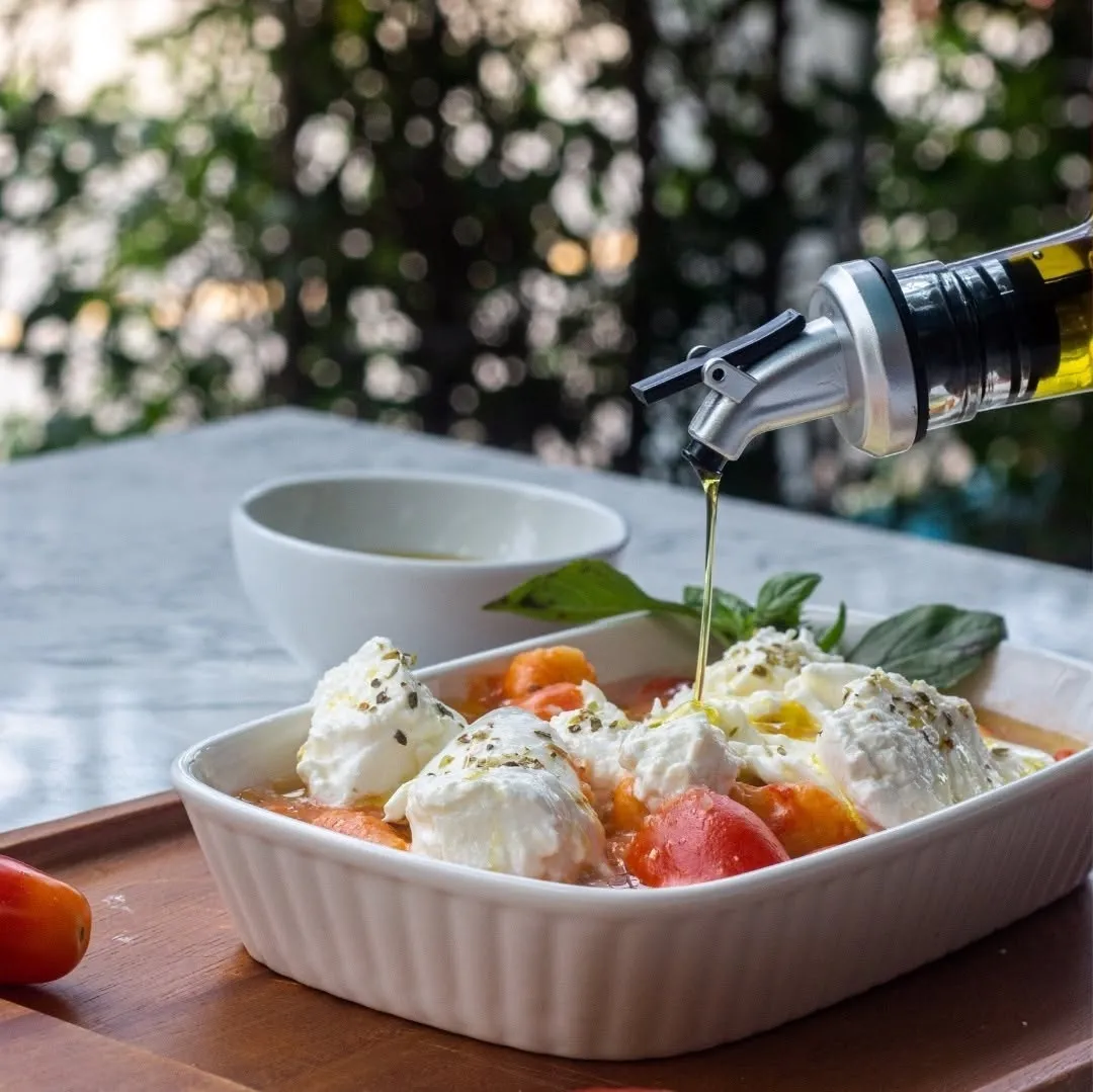 Burrata, tomato and olive oil dish at Allegro