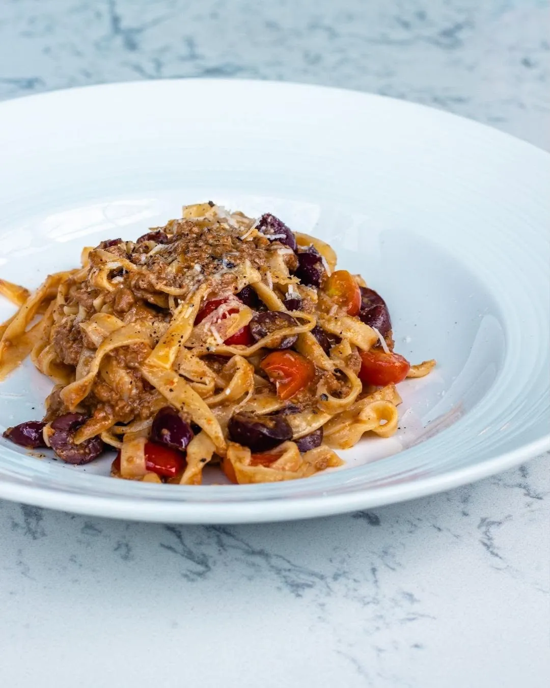 Italian tagliatelle with tomato and olives