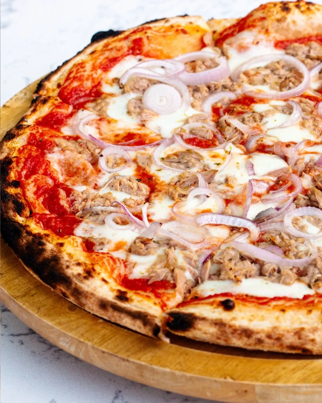 Fresh wood-fired pizza served at Allegro
