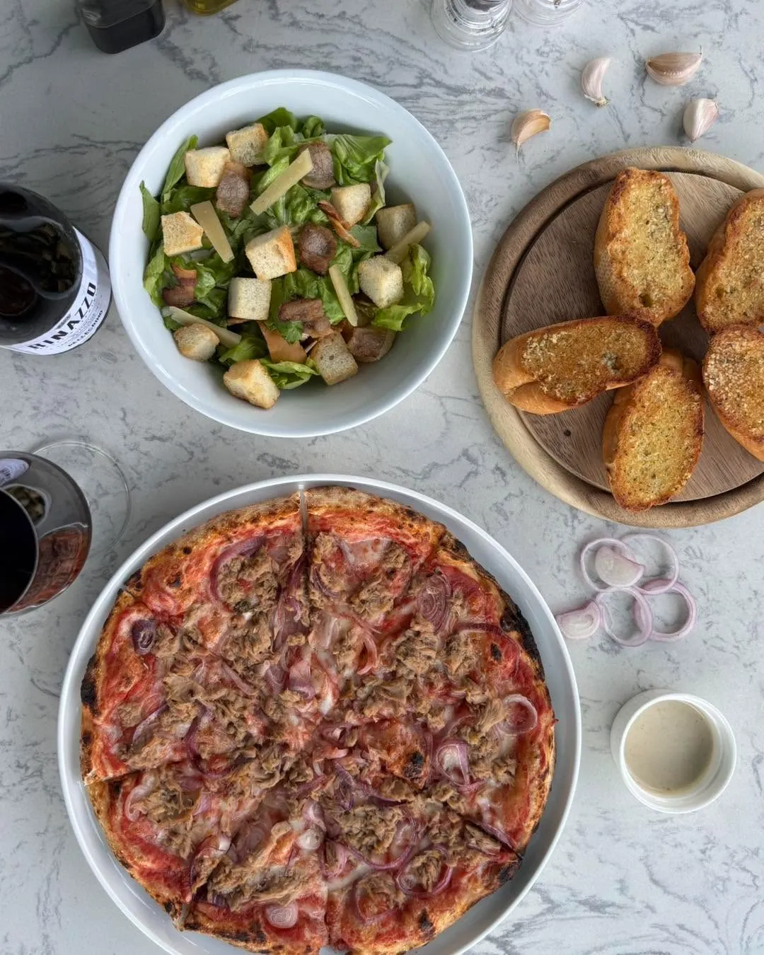 Close-up of wood-fired tuna and onion pizza