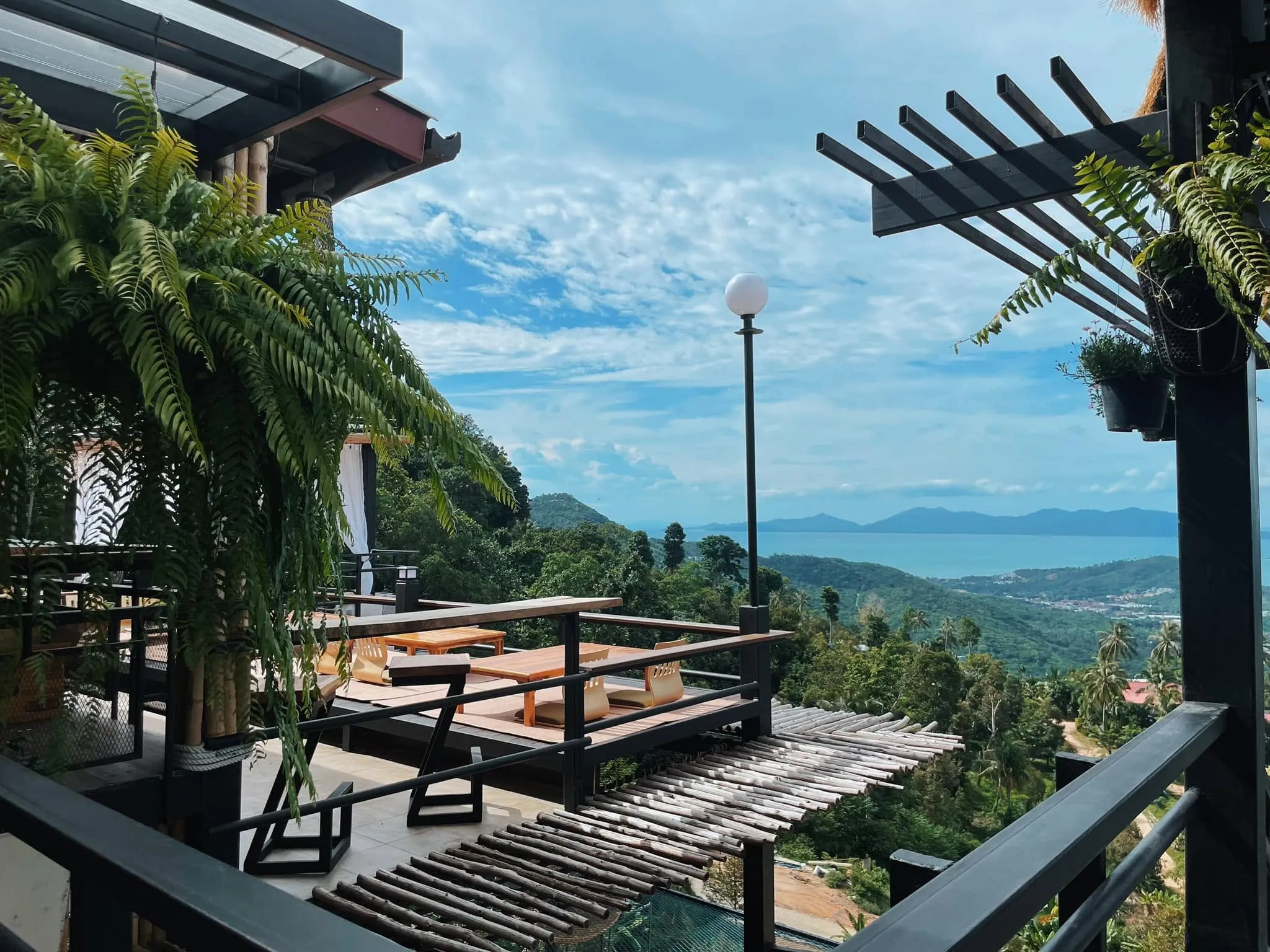 Open-air terrace overlooking the hills and sea at Highland Paradise