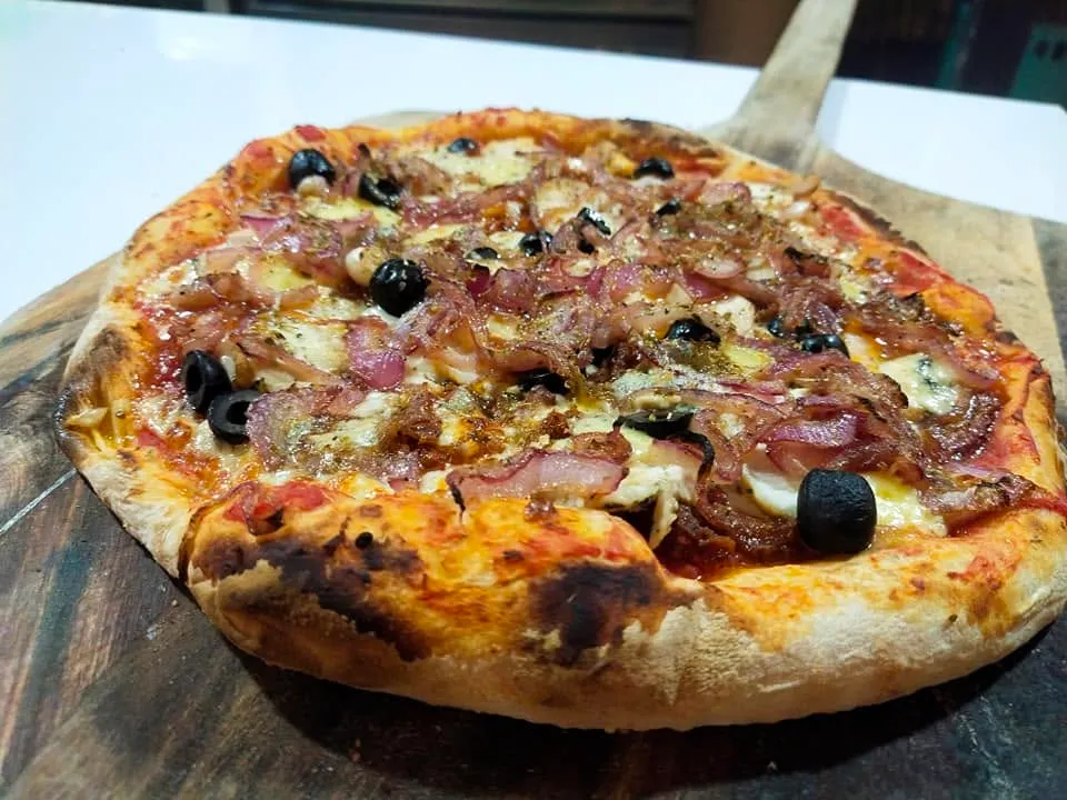 Italian pizza with mushrooms, olives and red onion