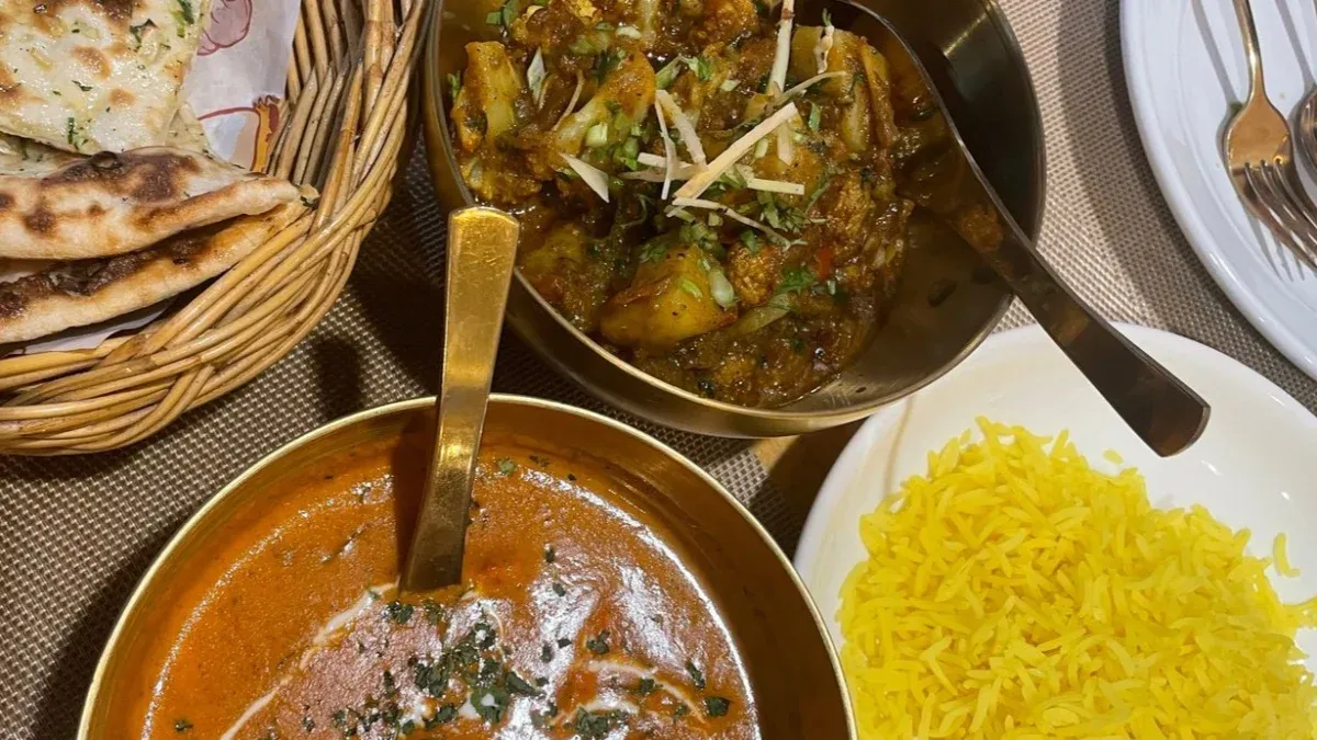 Indian curries with yellow rice and fresh naan