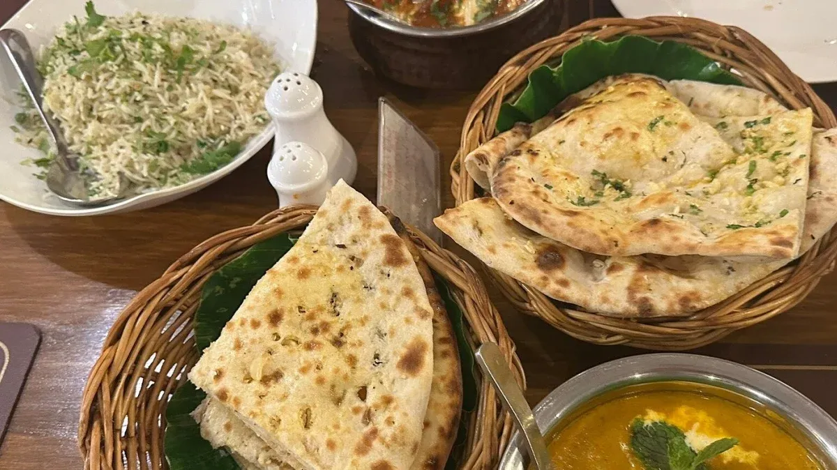 Fresh naan breads served with Indian curries and rice