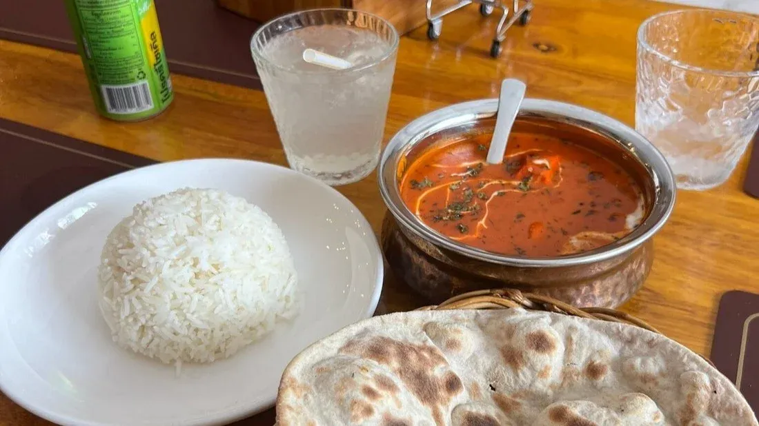 Indian curry served with rice and flatbread