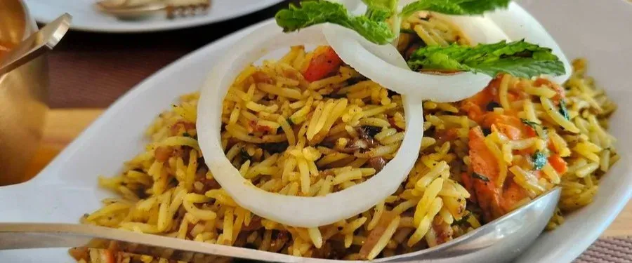 Fragrant Indian biryani served with vegetables