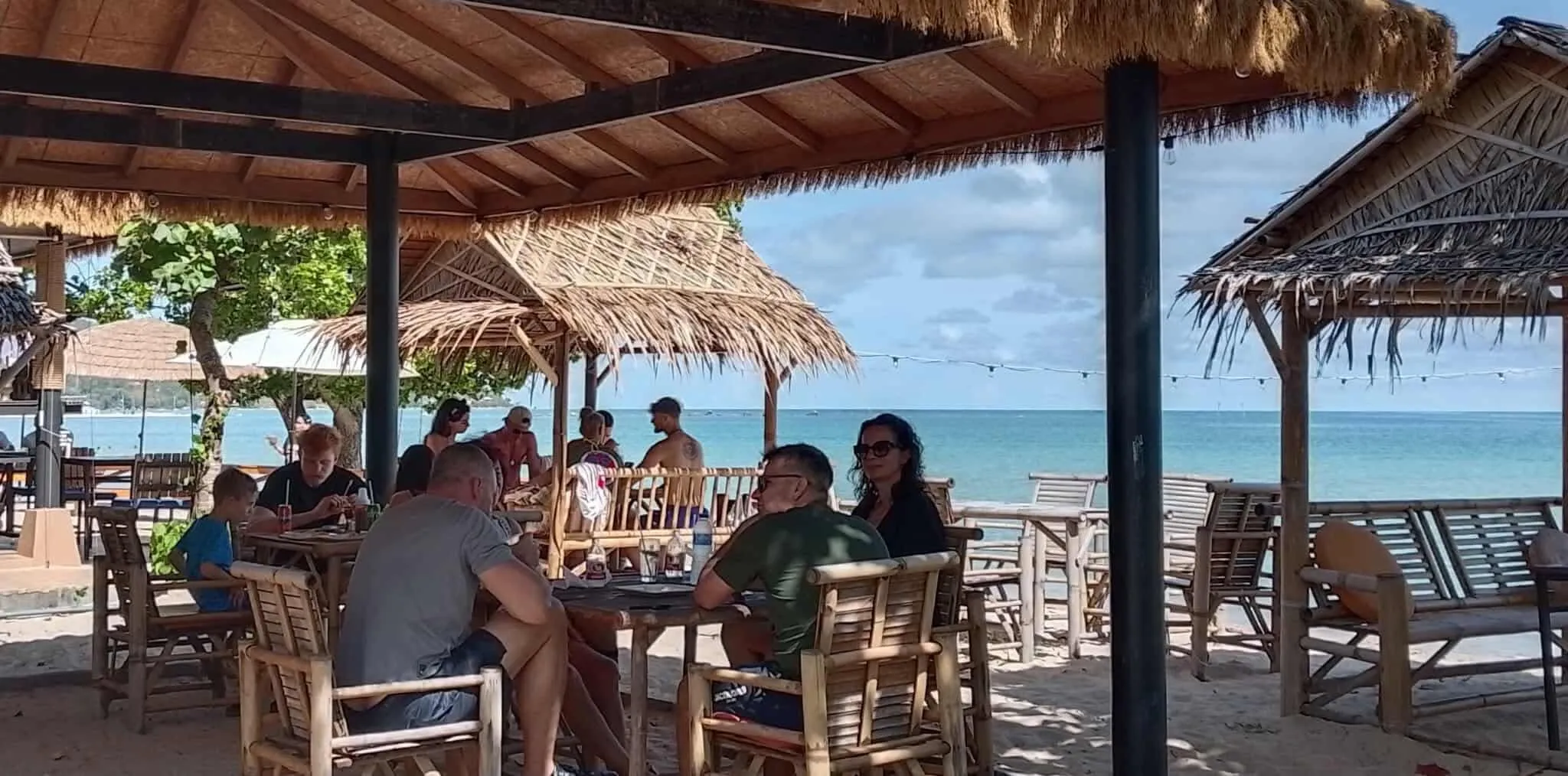 Guests dining beside the beach at The Reef